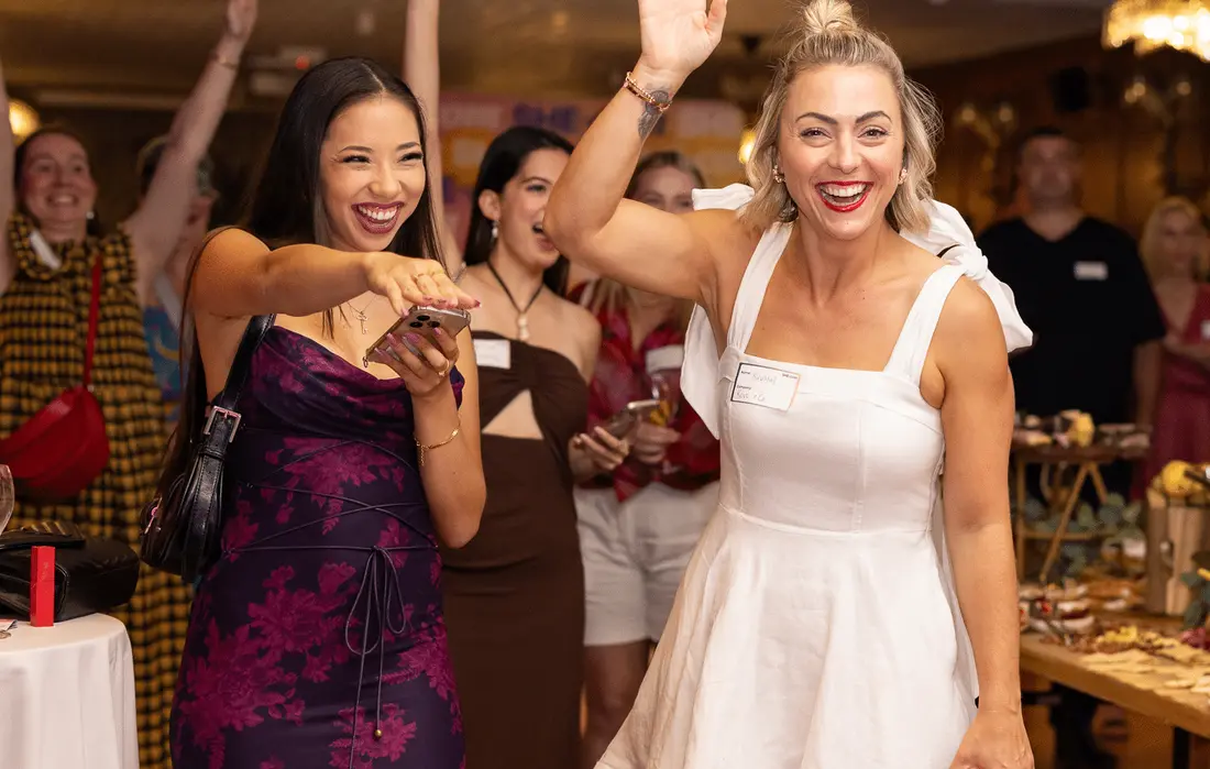 Founders celebrating at a SHE-com event